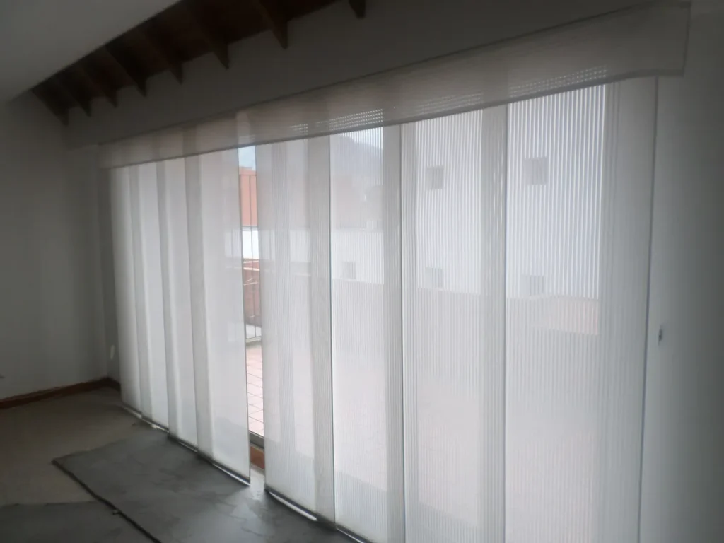 Panel japonés de tela translúcida en un ventanal que da a una terraza